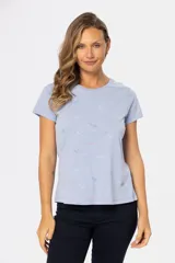 Remera color beige con estampado de aves en tonos celeste, lila y dorado.