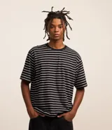 Remera boxy de algodón a rayas blancas y negras, con cuello redondo y mangas cortas.