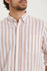 Camisa de lino a rayas verticales azules y blancas, de manga larga con puños abotonados y cuello clásico.