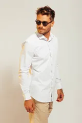 Camisa blanca de vestir con finas rayas verticales celestes, de corte clásico y manga larga.