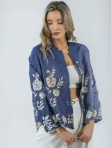 Camisa de jean azul con bordado de flores en tonos champagne y cobre, cuello mao y corte amplio.