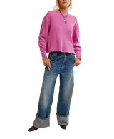 Buzo blanco de algodón con escote a la base, hombros caídos y mangas amplias con detalle de ojalillos y cordones en los puños.