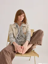 Chomba de punto color beige con cuello polo y mangas cortas.