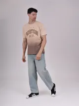 Remera beige con degradé marrón en la parte inferior y estampado con la palabra "Boston" en marrón.