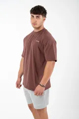 Remera marrón de algodón con estampado blanco en la espalda con la palabra "PERSISTENCE".