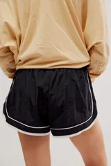 Short deportivo negro con ribete blanco en el ruedo y los laterales, cintura elastizada con logo en etiqueta frontal.