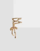 Aro cuff dorado con dije de moño con strass rosa.