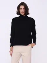 Sweater negro tipo polera con botones en los hombros y cortes amplios.