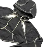 Buzo negro corto con capucha y espalda descubierta, con tiras para atar en la espalda y detalles de costuras blancas.