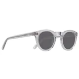 Lentes de sol con montura redonda transparente y lentes grises.