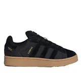 Championes de gamuza negra con tres franjas laterales y suela de goma color crema.