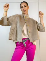 Chaqueta corta color camel de gamuza, con cuello alto, mangas anchas 3/4 y cierre frontal con botones de madera.