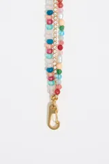 Collar corto de tres hilos: uno de cuentas de colores, otro de strass y otro de cadena dorada con dijes de animales marinos y aves tropicales.