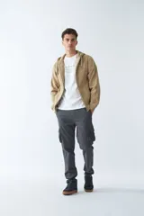 Campera de felpa color beige con cierre frontal, capucha con cordón ajustable, bolsillos laterales y logo estampado en el pecho.