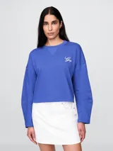 Buzo canguro negro de algodón sin felpa, con cuello redondo y logo Gap bordado en blanco en el frente.