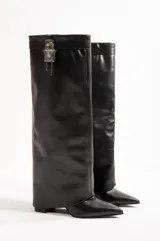 Botas de cuero negro de caña alta con punta fina y taco aguja.