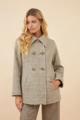 Chaquetón de lana fina color beige con cuello solapa, doble abotonadura frontal, bolsillos ojal y forro al tono.