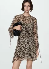 Vestido corto con estampado animal print, cuello redondo y mangas largas con lazos en los puños.