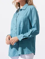 Camisa blanca de lyocell, marca Dash. Tiene cuello con solapa, abertura central con botones, mangas largas regulables con presilla y botón, y dos bolsillos delanteros aplicados.