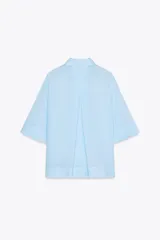 Camisa marrón de corte recto, con cuello solapa, manga corta y cierre frontal con botones.