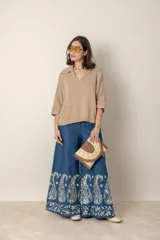 Blusa italiana tejida color beige, con cuello polo, mangas murciélago y corte holgado.