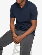 Chomba azul marino de manga corta, con cuello clásico y tapeta de dos botones. Logo de Calvin Klein bordado en el pecho.