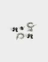 Set de tres pares de aros plateados con pasantes: un par con forma de moño, un par con forma de rosa y un par con forma de argolla con textura de cadena.
