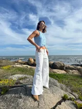 Pantalón jean blanco de tiro bajo y corte acampanado.