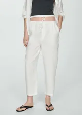 Pantalón blanco de lino con cintura elástica ajustable con cordón.