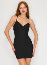 Mini vestido negro con escote en V y tirantes finos.