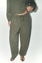 Pantalón verde oliva de tiro alto con bolsillos delanteros y traseros. Cintura elástica ajustable con cordones y pierna ancha.
