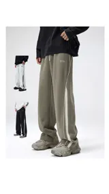 Pantalón deportivo estilo jogging, color verde oliva, con cintura ajustable con cordón y bolsillos laterales. Presenta una franja lateral doble en color blanco.