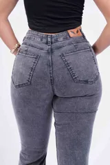 Pantalón de jean acampanado gris con efecto lavado, tiro alto y cinco bolsillos.