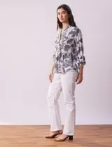 Blusa de gasa estampada con cuello a la base, escote en V y botones. Delantera con detalle plisado y largo de manga regulable con presilla y botón.