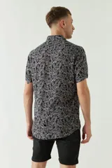 Camisa de hombre estampada, de manga corta y fit slim. Presenta cartera abotonada y logo bordado.