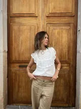 Blusa blanca de lino con tul bordado en algodón, cuello redondo y volados en los hombros.