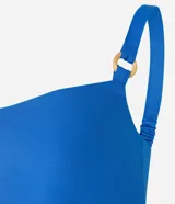 Blusa cropped de viscolino azul con escote en V, breteles con adornos y lastex en la espalda.