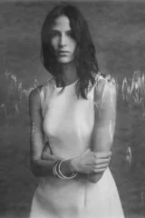 Vestido corto blanco de cuello redondo y sin mangas. Falda con pliegues y volumen. Cierre trasero con cremallera oculta.