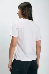 Remera color crudo de corte recto con estampado de un águila y la palabra 'Liberty' en color amarillo.