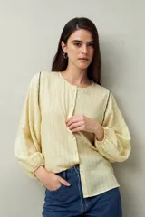 Camisa blanca a rayas grises, de lino, con cuello mao, mangas largas abullonadas y bordados en las sisas.