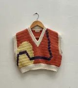 Chaleco tejido a crochet con escote en V, color beige con detalles en blanco, marrón y verde.