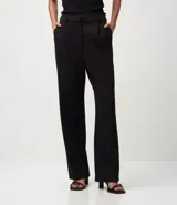 Pantalón femenino de punto roma color azul marino, de corte recto, con pliegues frontales y bolsillos laterales.