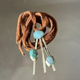 Collar con dije de bronce y ágatas en tonos de verde agua engarzadas y pegadas, tiento de cuero color camel.
