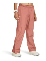 Pantalón deportivo Under Armour Rush OS Woven para mujer, color rosa, de corte holgado, con cintura elástica, bolsillos laterales y cierres en los tobillos. Confeccionado en tejido con infusión de minerales que ayuda a combatir la fatiga.