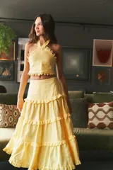 Falda larga color amarillo pálido, de lino, con cintura elastizada y corte escalonado con volados.