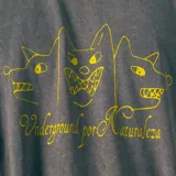 Remera gris de corte oversize con estampa amarilla de tres perros de estilo dibujo infantil y texto "Underground por Naturaleza".