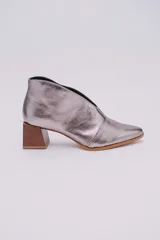 Botines color peltre de cuero con taco de madera y corte en V en el frente.