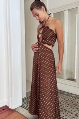 Vestido largo con estampado paisley en tonos tierra y azules, con top halter y cut-outs laterales. La falda es holgada y tiene elástico en la cintura.