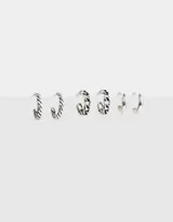 Set de tres pares de aros tipo argolla bañados en plata, con diferentes diseños: argolla trenzada, argolla con eslabones y argolla lisa.