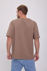 Camiseta marrón de manga corta y cuello redondo con estampado frontal con texto en color azul.